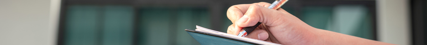Pen writing on a Clipboard