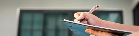 Pen writing on a Clipboard